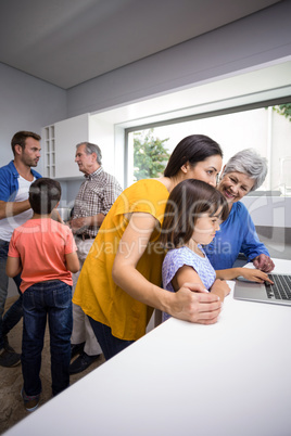 Happy family interacting using laptop