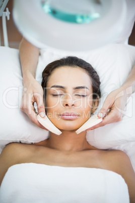 Close-up of woman receiving facial massage