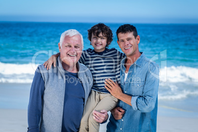 Male family members posing at the beach