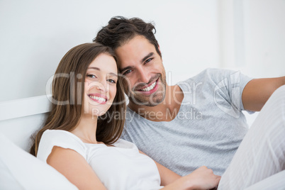 Happy couple relaxing on bed