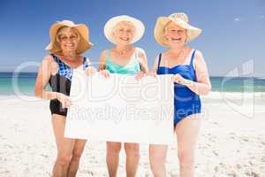Senior woman friends holding blank paper