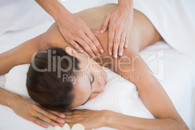 Woman receiving massage at health spa