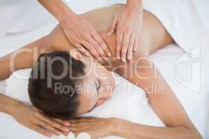 Woman receiving massage at health spa