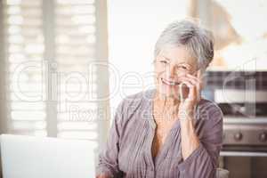 Portrait of happy senior woman talking on mobile phone