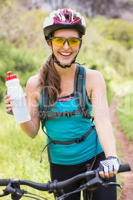 Smiling woman standing next to her bike