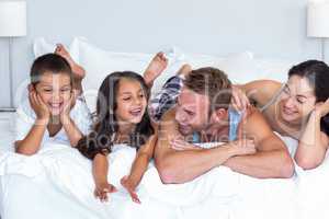 Happy family in their bedroom