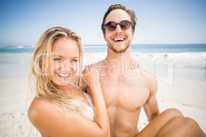 Man holding woman in his arms on the beach