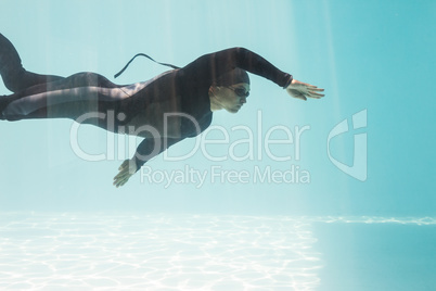 Young man with arm raised while swimming