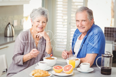 Portrait of smiling senior couple having breakfast Portrait of smiling senior couple having breakfast
