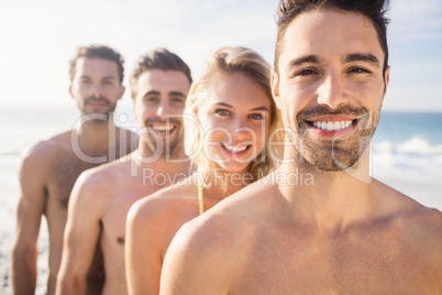 Smiling friends standing in line