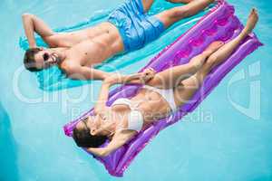 Happy couple relaxing on inflatable raft