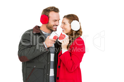 Happy young couple holding coffee mug