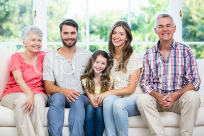 Happy family sitting on sofa at home