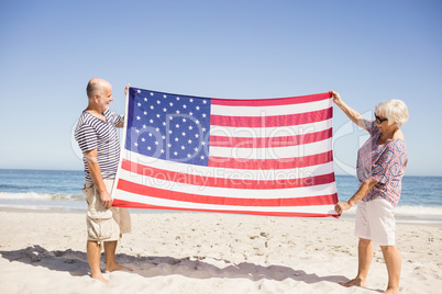 Senior couple holding american flag together