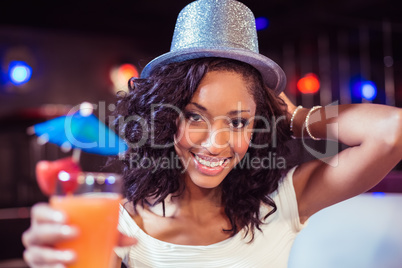 Pretty girl with cocktail and glitter hat