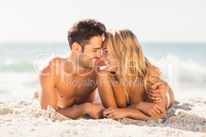 Young couple lying on sand