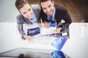 Business people discussing over graphs in office