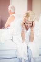 Tensed senior couple in bedroom