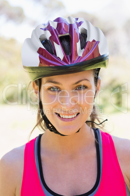 Fit smiling woman wearing helmet