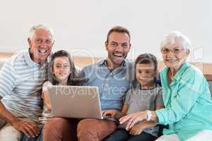 Happy family sitting on sofa