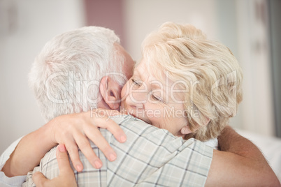 Close-up of happy senior couple embracing