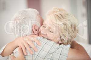 Close-up of happy senior couple embracing