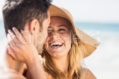 Young couple sitting on sand