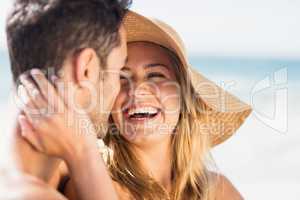 Young couple sitting on sand