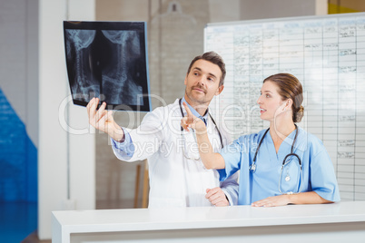 Doctors examining X-ray by chart