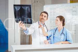Doctors examining X-ray by chart