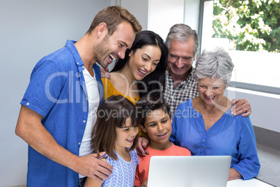 Happy family interacting using laptop