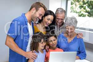 Happy family interacting using laptop