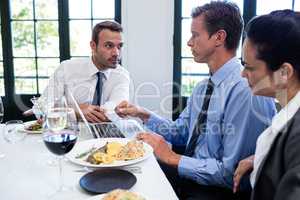 Businessmen discussing during a business lunch meeting
