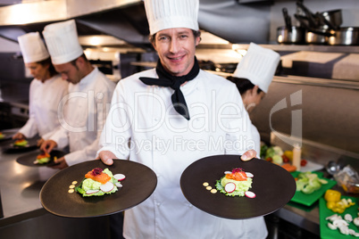 Happy head chef presenting his food plates