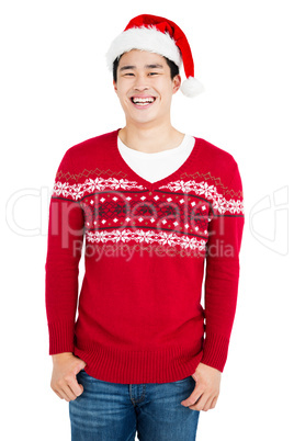 Young man wearing santa hat looking at camera and smiling