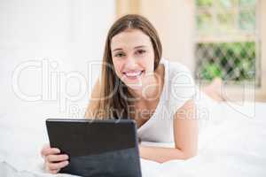 Portrait of happy woman holding digital tablet