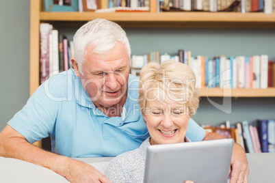 Senior couple using digital tablet