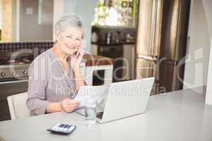 Happy senior woman talking on mobile phone