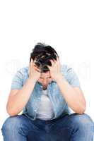 Frustrated man sitting with his hands on head