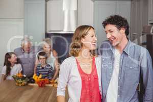 Happy family laughing in kitchen
