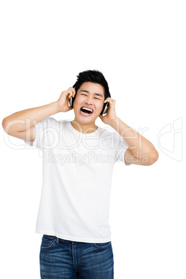 Young man listening to music on headphones