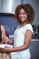 Portrait of happy woman preparing food