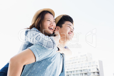 Young man giving a piggyback ride to woman