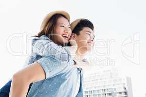 Young man giving a piggyback ride to woman