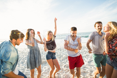 Friends dancing on the beach