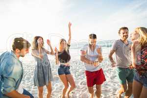 Friends dancing on the beach