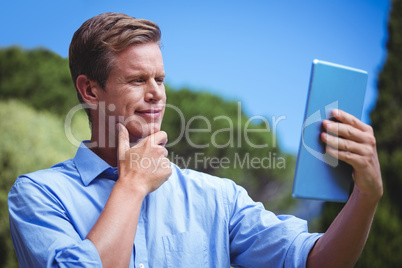 Handsome businessman using tablet computer