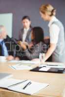 Organizer with pen on table in conference room