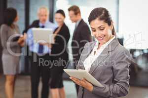 Happy businesswoman using digital tablet