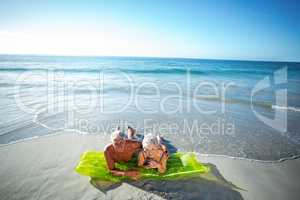 Senior couple lying on air mattress